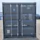 A shipping container with weight specifications and branding in the background. Industrial setting.