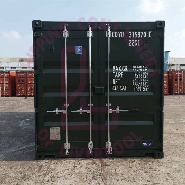 A shipping container with specifications, set against a backdrop of other containers at a dock.