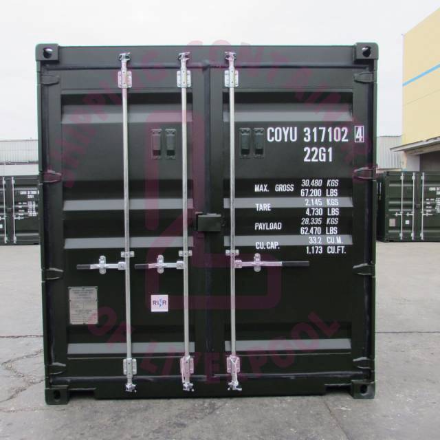 A shipping container with weight specifications and branding visible, set against a warehouse backdrop.