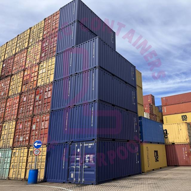 A stack of colorful shipping containers in a port, showcasing a port sign and a clear blue sky above.