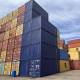 A stack of colorful shipping containers in a port, showcasing a port sign and a clear blue sky above.